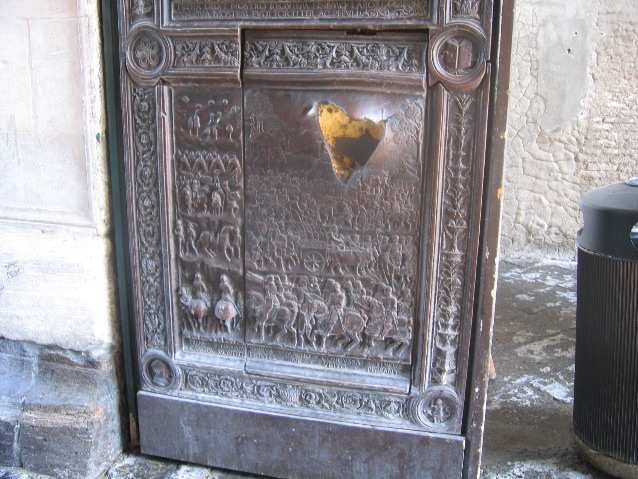 A scar from a cannon ball fired upon the Genovese ship that was carrying the door away